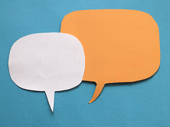 a white speech bubble and orange speech bubble